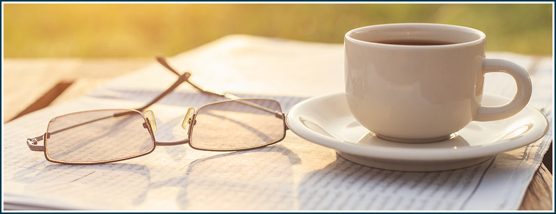 coffee newspaper and reading glasses