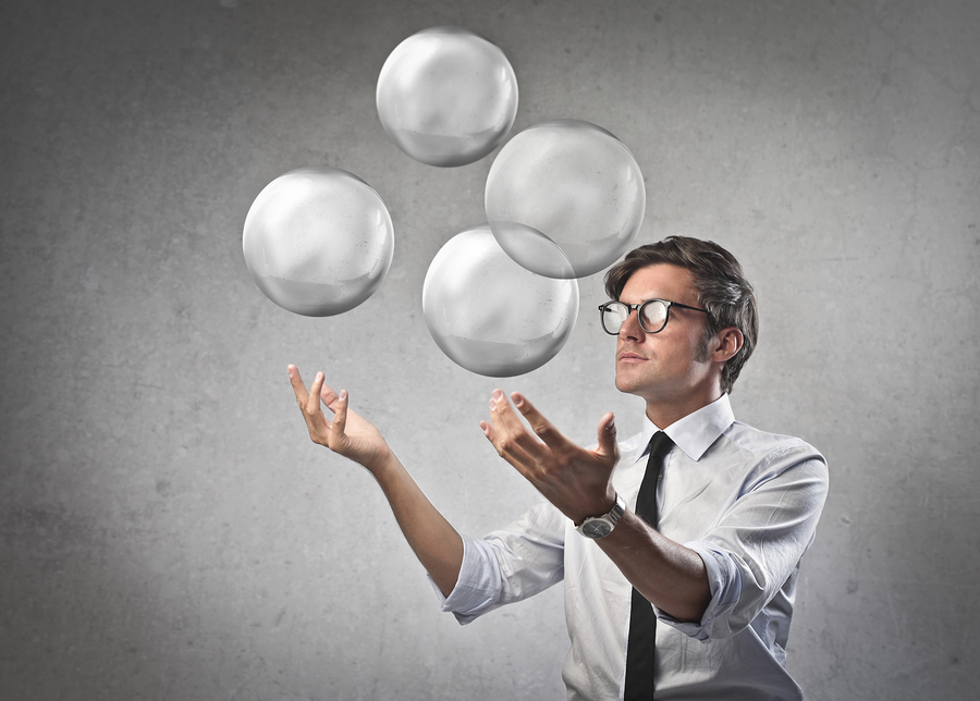 Businessman juggling with some air bubbles